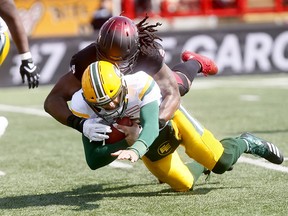 Calgary Stampeders Junior Turner sacks Edmonton Eskimos quarterback Mike Reilly during the Labour Day Classic at McMahon Stadium in Calgary on Monday, Sept. 3, 2018.