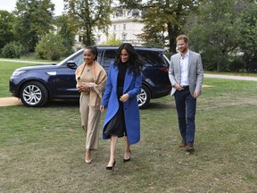 Meghan, the Duchess of Sussex, centre, accompanied by Britain's Prince Harry, the Duke of Sussex and her mother Doria Ragland walk to attend a reception at Kensington Palace, in London, Thursday Sept. 20, 2018. Markle was joined by her mother for the launch of a cookbook aimed at raising money for victims of the Grenfell fire. Markle, now the Duchess of Sussex, hosted the reception beside her mother, Doria Ragland, to support the cookbook called "Together."
