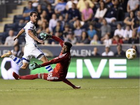 Montreal Impact's Alejandro Silva, left, takes a shot and scores a goal past Philadelphia Union goalkeeper Andre Blake in the first half of an MLS soccer match on Saturday, Sept. 15, 2018, in Chester, Pa.