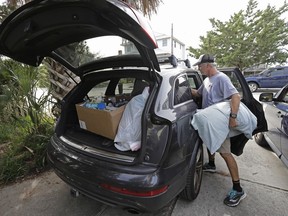 Jason Moore of Raleigh, N.C., packs to evacuate from Wrightsville Beach, N.C., Wednesday, Sept. 12, 2018 as Hurricane Florence threatens the coast.