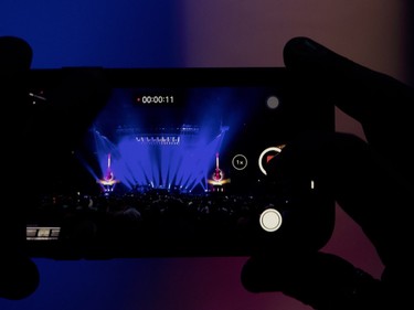 A fan takes a video with his mobile phone as Paul McCartney performs his Freshen Up Tour in Montreal on Thursday, Sept. 20, 2018.