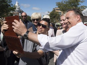 Coalition Avenir Quebec Leader Francois Legault gets his picture taken by a visitor while campaigning, Saturday, September 8, 2018 in Quebec City.