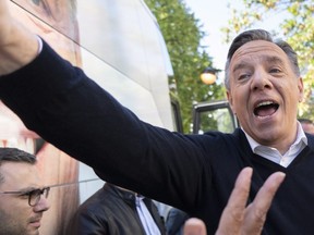 Coalition Avenir Québec Leader François Legault reaches out to supporters during a campaign stop in Ste-Anne-des Plaines on Saturday, Sept. 22, 2018.