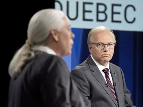 Parti Quebecois Leader Jean-Francois Lisee listens as Quebec Solidaire co-spokesperson Manon Masse speaks during the English language leaders' debate in Montreal Sept. 17, 2018.