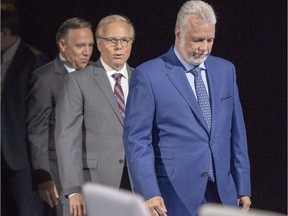 Liberal leader Philippe Couillard, right, PQ leader Jean-François Lisée and CAQ leader François Legault arrive for the photo session before their English debate Monday, September 17, 2018 in Montreal, Que.