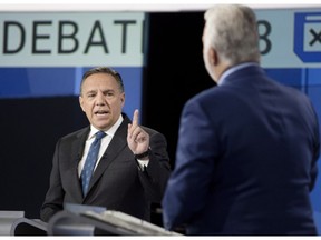 CAQ Leader François Legault, left, speaks to Liberal Leader Philippe Couillard during their English language debate, Monday, Sept. 17, 2018, in Montreal.
