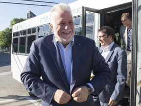 Quebec Liberal Leader Philippe Couillard smiles as he steps off a bus while campaigning, Tuesday, September 4, 2018 in Gaspe Que.