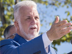 Quebec Liberal leader Philippe Couillard speaks to the media while campaigning Sept. 8, 2018 in Montreal.
