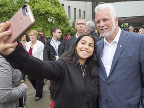 Quebec Liberal leader Philippe Couillard poses for a photo with a student at College Montmorency while campaigning Sept. 11.
