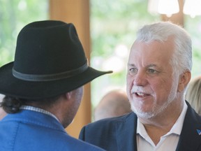 Quebec Liberal Party Leader Philippe Couillard speaks to a supporter during a campaign stop in Vaudreuil-Dorion on Sunday, September 23, 2018.