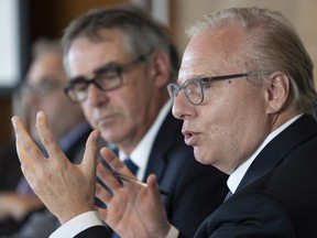 PQ Leader Jean-François Lisée addresses a meeting of the UPA, Quebec's farmers' association, as president Marcel Groleau listens during a campaign stop in Longueuil.