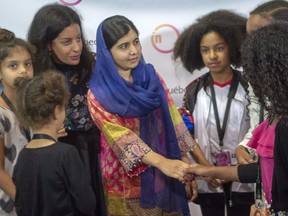 Nobel Prize laureate Malala Yousafza greets young guest at the Influence MTL conference Wednesday, September 26, 2018 in Montreal.