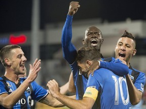 Impact's Micheal Azira, centre, celebrates his first half goal against the New York City FC during MLS soccer action in Montreal on Saturday, Sept. 22, 2018.
