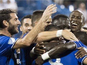 Impact players celebrate a goal by teammate Bacary Sagna against the New York Red Bulls during first half MLS soccer action in Montreal on Saturday, Sept. 1, 2018.