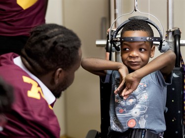 Maurice Simba of the Concordia Stingers football team speaks with 5-year-old Darion Andoson at the Shriners Hospital for Children in Montreal on Wednesday, Sept. 26, 2018. The Stingers visited with patients at the hospital before hosting the 32nd edition of the Shrine Bowl fundraising game on Saturday at 2 p.m. against the Université de Laval Rouge et Or. The Karnak Shriners, organizers of the event, announced that this year the Shrine Bowl will reach $1 million raised since its inception in 1987.