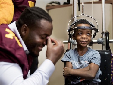 Maurice Simba of the Concordia Stingers laughs as he listens to 5-year-old Darion Andoson at the Shriners Hospital for Children in Montreal on Wednesday, Sept. 26, 2018. The Stingers visited with patients at the hospital before hosting the 32nd edition of the Shrine Bowl fundraising game on Saturday at 2 p.m. against the Université de Laval Rouge et Or. The Karnak Shriners, organizers of the event, announced that this year the Shrine Bowl will reach $1 million raised since its inception in 1987.