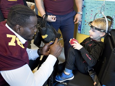 Maurice Simba of the Concordia Stingers chats with Garron Clarke, 5, at the Shriners Hospital for Children in Montreal on Wednesday, Sept. 26, 2018. The Stingers visited with patients at the hospital before hosting the 32nd edition of the Shrine Bowl fundraising game on Saturday at 2 p.m. against the Université de Laval Rouge et Or. The Karnak Shriners, organizers of the event, announced that this year the Shrine Bowl will reach $1 million raised since its inception in 1987.