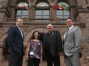 Concussion Legacy Foundation co-founder and CEO Chris Nowinski, PhD, left, and Tim Fleiszer, executive director of CLF Canada, right, pose out front of Queen's Park with Gordon and Kathleen Stringer, middle, — who set up Rowan's Law, Canada's first concussion legislation.
