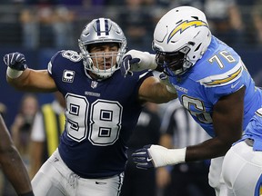 In this Nov. 23, 2017, file photo, Dallas Cowboys defensive end Tyrone Crawford (98) faces off against Los Angeles Chargers offensive tackle Russell Okung (76) during an NFL game in Arlington, Texas. (AP Photo/Sarah Warnock, File)