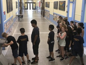 Students at Roslyn Elementary School in Westmount line up for the water fountain as students across Montreal try to beat the heat.