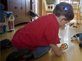 A child with a cochlear implant plays in their Montreal-area home in 2008.