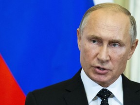 Russian President Vladimir Putin speaks to the media during a joint news conference with Hungarian Prime Minister Viktor Orban after their talks in the Kremlin in Moscow, Russia, Tuesday, Sept. 18, 2018. Putin says "a chain of tragic circumstances" is to be blamed for a Russian military aircraft shot down by a Syrian missile. He vowed to boost security for Russian troops there.