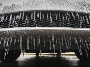 Icicles hang from the front of a minivan parked during freezing rain in Montreal.