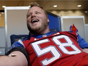 Alouettes' Luc Brodeur-Jourdain laughs while he gives blood during the team's annual blood drive in 2016, but he might tear up Sunday at Montreal's final home game as it could be the last appearance in Montreal of the 35-year-old centre.