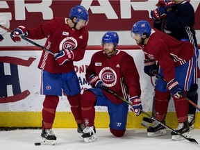 The Canadiens' Brendan Gallagher (left) speaks with line mates Tomas Tatar and Phillip Danault during practice at the Bell Sports Complex in Brossard on Sept. 25, 2018.