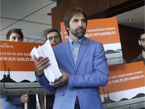 Steven Guilbeault of the environment group Équiterre holds 90,000 petitions signed by people against the TransCanada pipeline project in 2015.