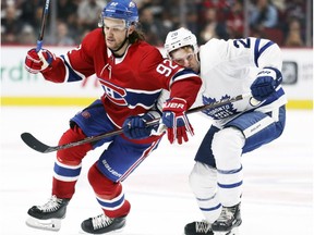 Montreal Canadiens' Jonathan Drouin uses his elbow to hold off Toronto Maple Leafs' Connor Brown in Montreal on Sept. 26, 2018.