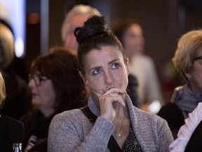 Nathalie Blackburn watches as results are broadcast as she waits for Liberal party leader Philippe Couillard to speak in St-Felicien Oct. 1, 2018.