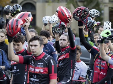 Cyclists observe a minute of silence on Thursday, Oct. 4, 2018, before will riding up Camillien Houde Way on Mount Royal to commemorate the first anniversary of the death of Clement Ouimet, who was killed in 2017 when his bike collided with a car on the mountain.