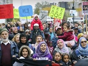 Families take part in an antiracism demonstration through the streets of Montreal on Sunday, Oct. 7, 2018.