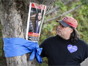 Todd Galganov indicates a poster which shows the now $500,000 reward for information to help locate his son Jesse Galganov, the Montreal hiker who went missing in Peru a year ago.
