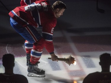 New Canadiens captain Shea Weber puts torch to ice during pre-game ceremonies ahead of team’s home opener at the Bell Centre in Montreal on Oct. 11, 2018.