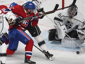 Canadiens' Artturi Lehkonen tries to squeeze past Los Kings' Derek Forbort to get to puck in front of goaltender Jack Campbell Thursday night at the Bell Centre.