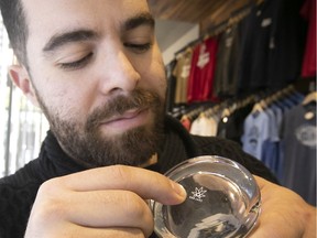 Jonathan Sarkis, store manager at Prohibition, with a glass bearing the image of a cannabis leaf. As of Oct. 17, it will be illegal to sell any merchandise that features a picture of a pot leaf or the number 420 in Quebec.
