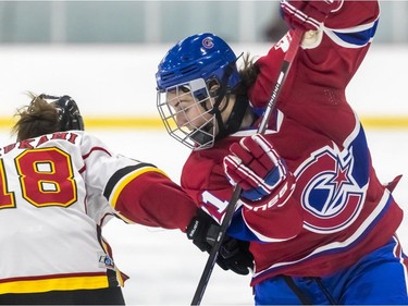 Montreal Canadiennes' Hilary Knight and Calgary Inferno Aina Mizukami during a 3-1 loss to Calgary at Place Bell in Laval on Sunday October 14, 2018.