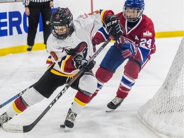 Montreal Canadiennes' Ann-Sophie Bettez chases the puck against Calgary Inferno's Tori Hickel during a 3-1 loss to Calgary at Place Bell in Laval on Sunday October 14, 2018.
