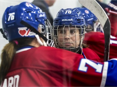 Montreal Canadiennes' Karell Emard and Tracy-Ann Lavigne (78) chat on the bench during a 3-1 loss to the Calgary Inferno at Place Bell in Laval on Sunday October 14, 2018.