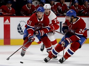 Canadiens winger Brendan Gallagher carries the puck alongside Phillip Danault, right, as Red Wings' Dylan Larkin follows the play Monday night at the Bell Centre. Fans have been enjoying the new-look Habs so far this year.