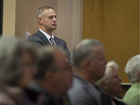 Dollard-des-Ormeaux Mayor Alex Bottausci listens to a presentation at Dollard's Community Centre, about the unpopular, above-ground Hydro-Québec project.