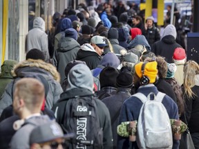 People wait to get into the downtown Société québécoise du cannabis in Montreal on Oct. 18, 2018, one day after the recreational use of cannabis became legal in Canada.