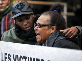 Erma Gibbs is comforted by her daughter Tricia Gibbs as she cries out while speaking at a vigil outside the Montreal Police Brotherhood office in Montreal Monday October 22, 2018 by families of people who have been killed by police.  Nicholas Gibbs was shot and killed by Montreal police this past August 21st.
