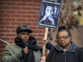Erma Gibbs, mother of Nicholas Gibbs, listens as her daughter Tricia speaks at a vigil outside the Montreal Police Brotherhood office in Montreal Oct. 22, 2018, by families of people who have been killed by police.