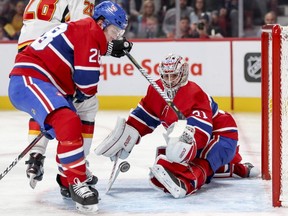 Canadiens goalie Carey Price makes a save as defenceman Mike Reilly looks to clear the rebound during second period Tuesday night at the Bell Centre.