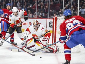 Canadiens' Jonathan Drouin eyes a loose puck in front of Flames goalie David Rittich during first period Tuesday night at the Bell Centre.