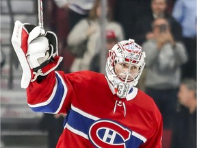 The Canadiens' Carey Price salutes fans at the Bell Centre in Montreal after a 3-2 victory over the Calgary Flames at the Bell Centre on Oct. 23, 2018 to tie Patrick Roy for No. 2 on the all-time wins list for Canadiens goalies with 289.