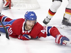 Joel Armia reaches for loose puck during first period against the Calgary Flames in Montreal Tuesday, Oct. 23, 2018.